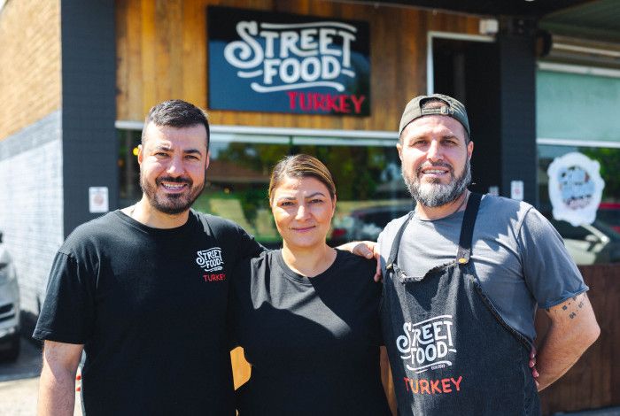Three people from Street food turkey infront of their business