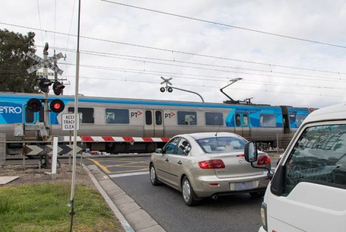 Image of level crossing and cars