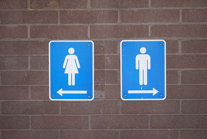Lady and man sign for toilets