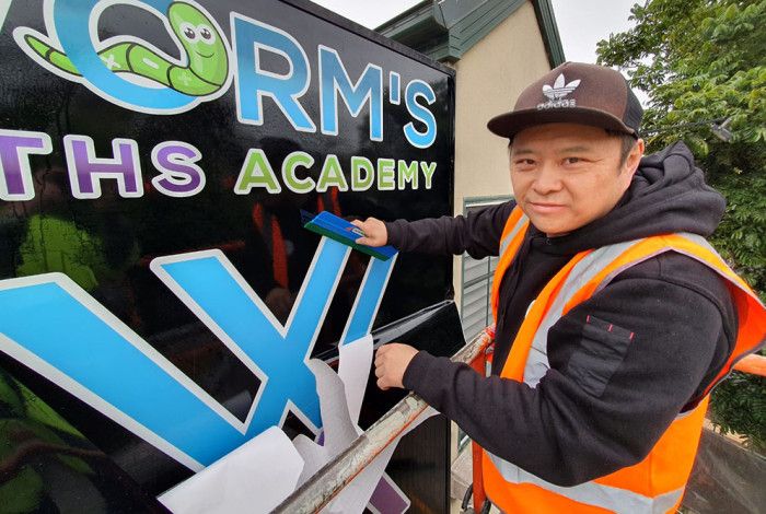 Man putting up a sign