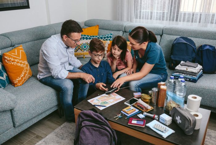 image of family at coffee table planning