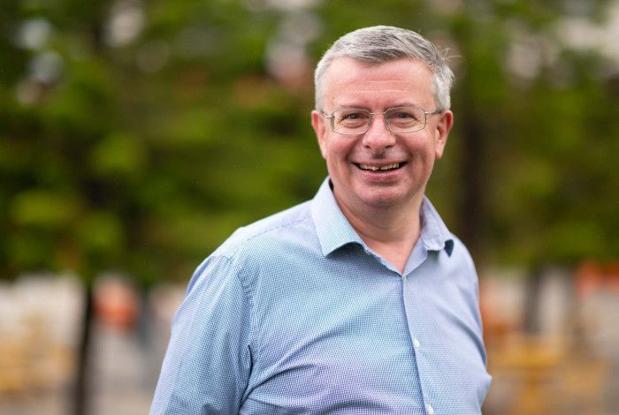 Matthew Kirwan - portrait of a man with short hair and a blue checked shirt