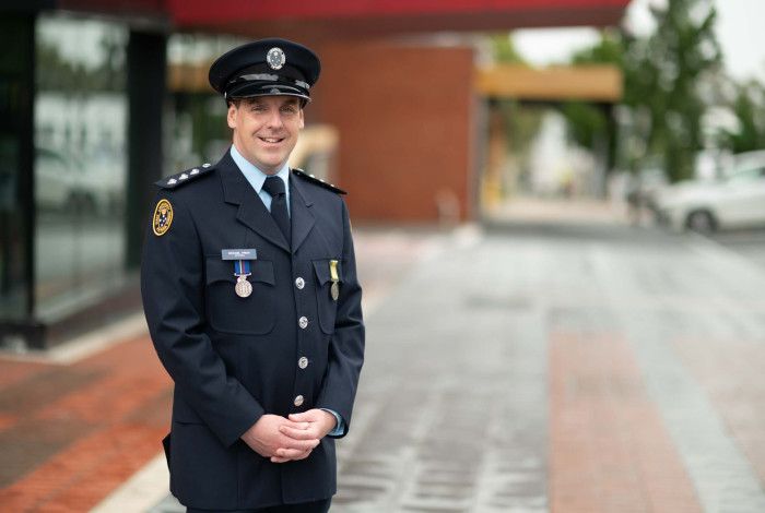 Michael Prior - portrait of a man in an official blue uniform with a hat on