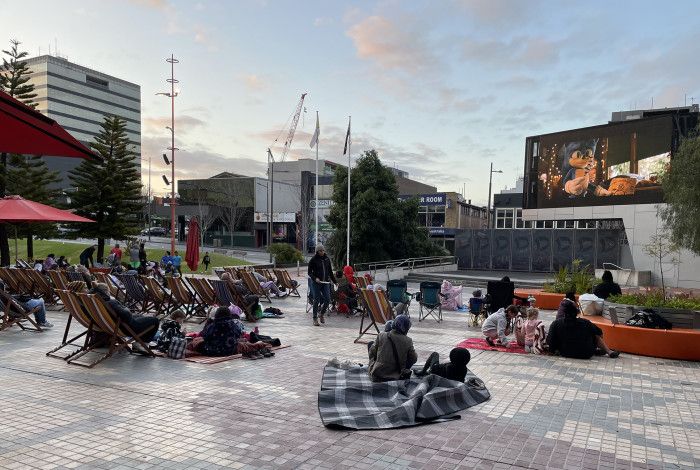 People sitting in Harmony Square