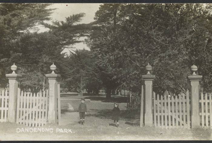 Sepia image of a young boy and girl standing at the entrance to Dandenong Park in circa 1912