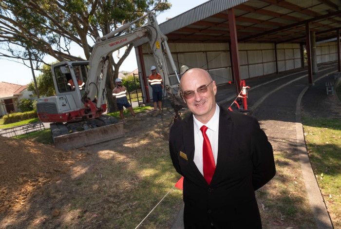 Councillor Sean O'Reilly standing in front of a work site.