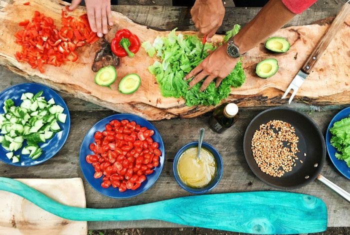 An array of healthy foods on a chopping board being prepared.