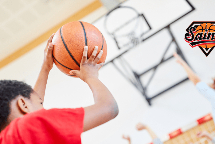 Boy shooting a basketball into a ring