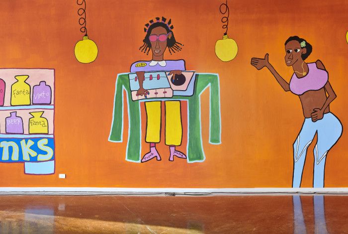 large scale mural depicting people at a music event and cafe