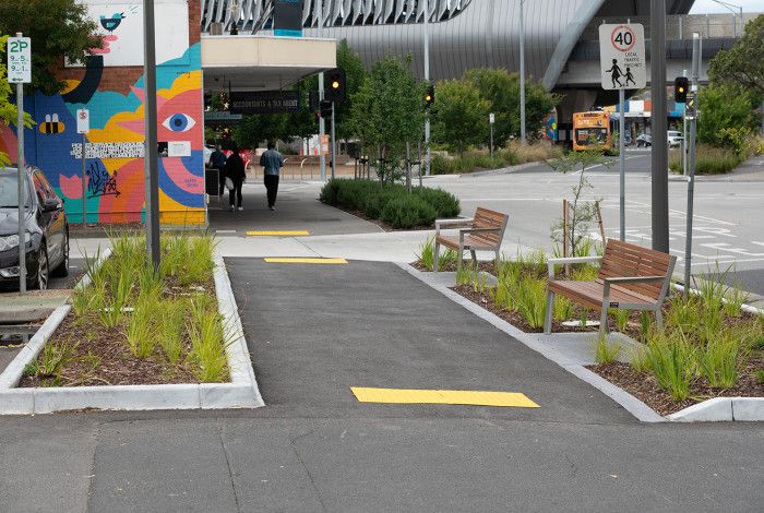 Image of a footpath and shops in the background