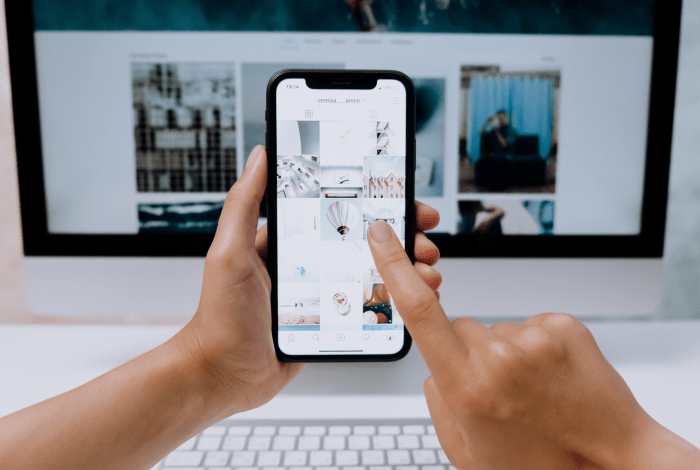 person creating content on iphone and computer