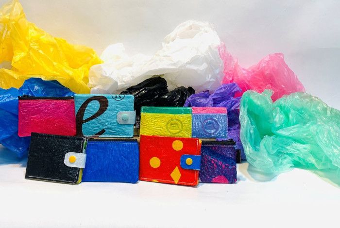Colourful plastic wallets surrounded by coloured soft plastic bags.