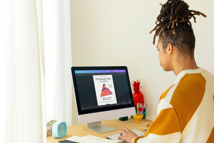 Person sitting at a desk using a computer.