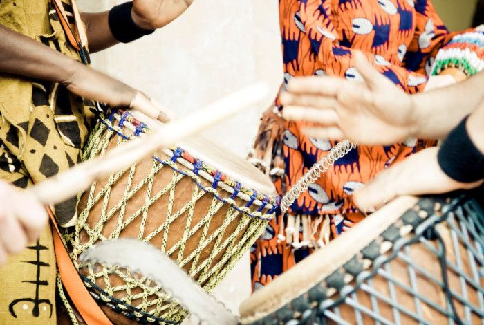 Four people drumming.