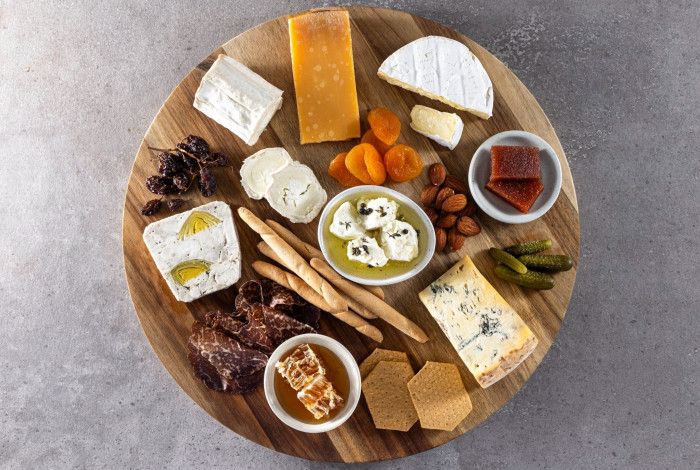 different cheeses and biscuits on a board