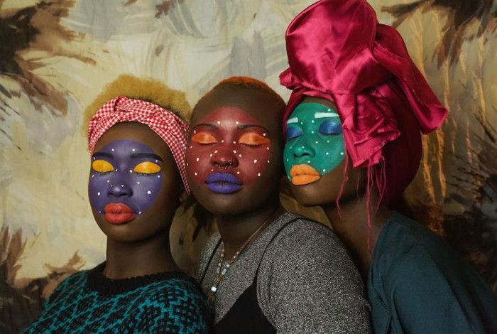 Three women with painted faces