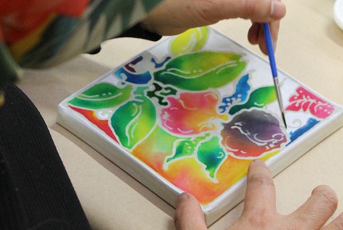 Someone engaged in batik painting.