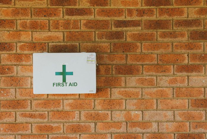 First Aid box mounted on a brick wall