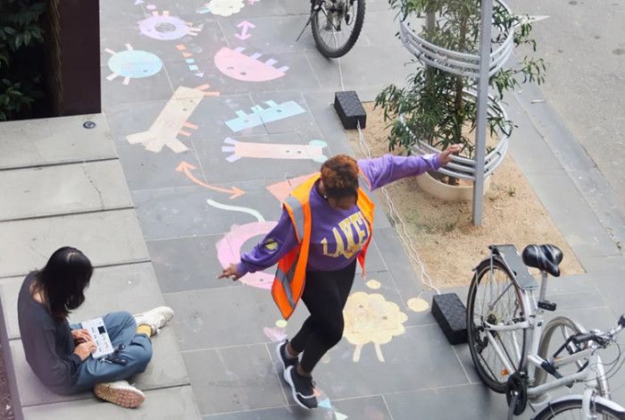 People playing on the footpath