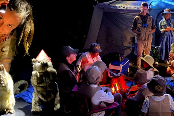 Camping tent and mock fire in a theatre