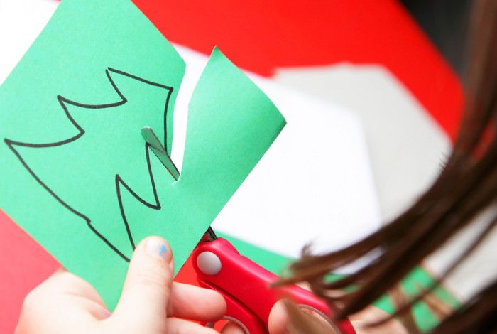 Someone cutting out a Christmas tree