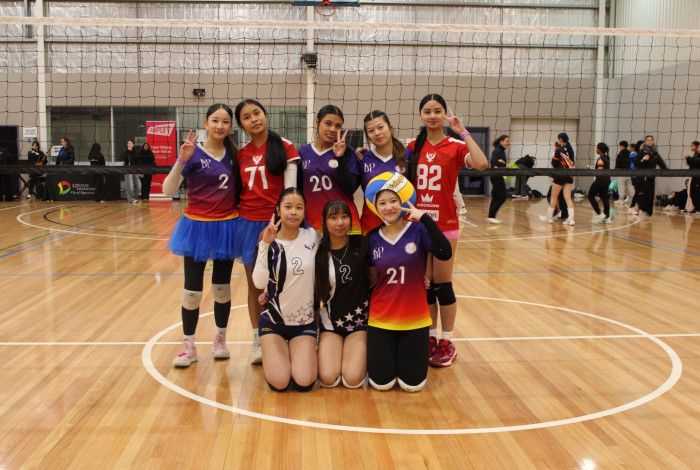 group of young people posing at a volleyball tournament