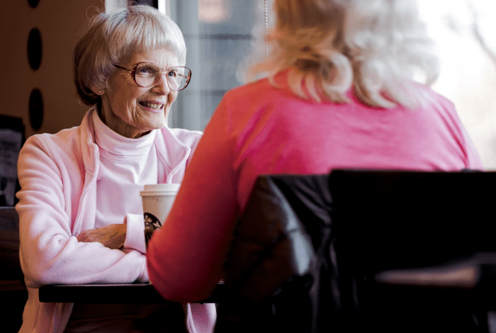 Two women chatting over a cup of coffe.