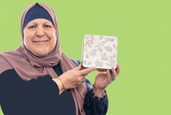 Woman holding a biscuit tin