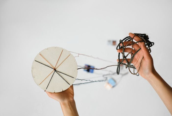 Kumihimo disk with various coloured threads.