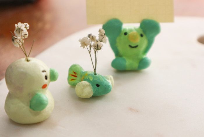 Images of air clay toys, with couple of flower branch on top