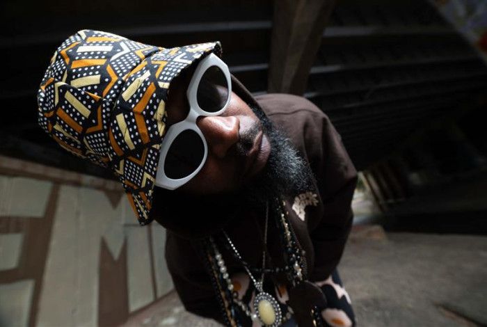 Mr. Congo posing for a photo in an alleyway 