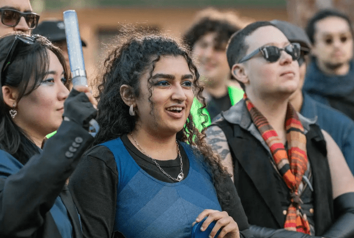 Group of people outdoors at an event in an urban environment.