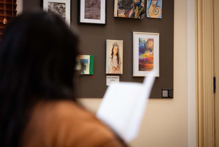 Person looking at 9 by 5 art on wall.