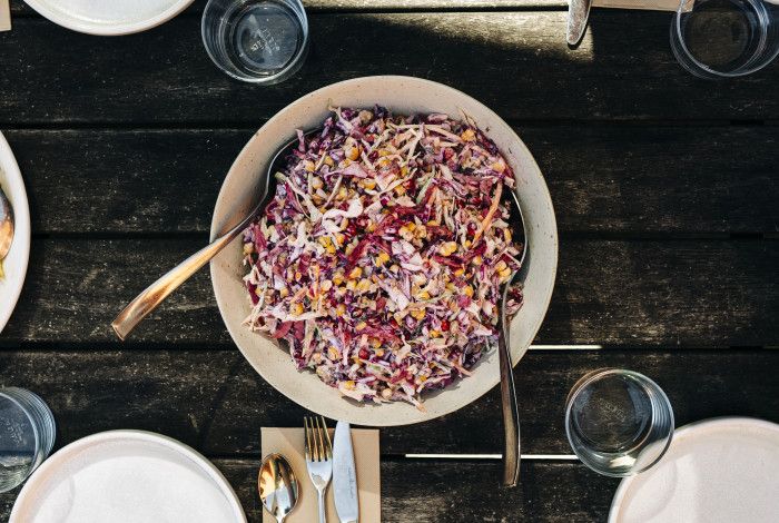A bowl of colourful pomegranate salad on the table.