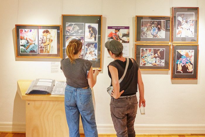 People looking at exhibition display.