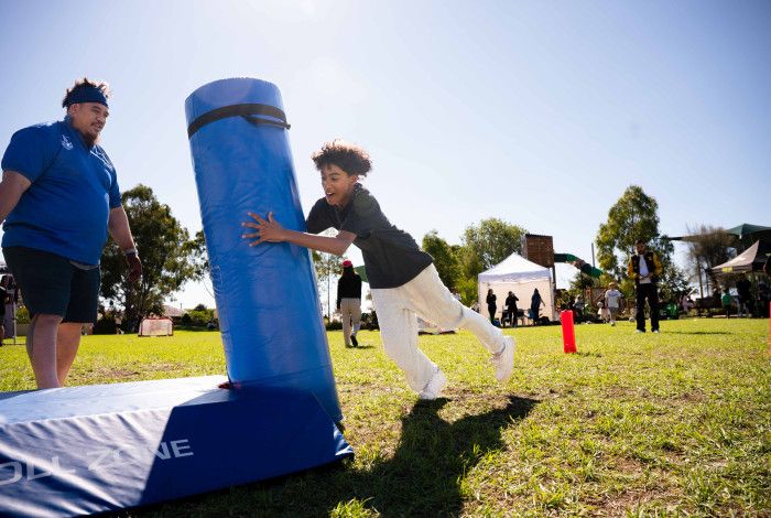 Child running up to tackling pad