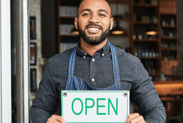 business owner holding sign
