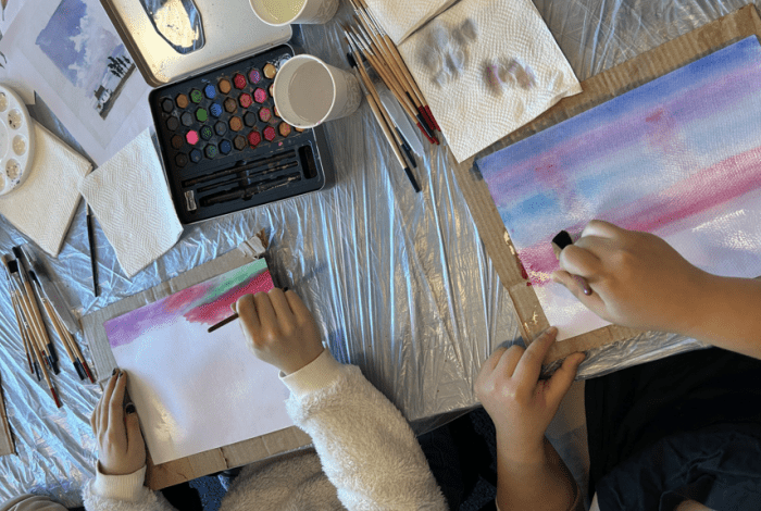 two young people painting