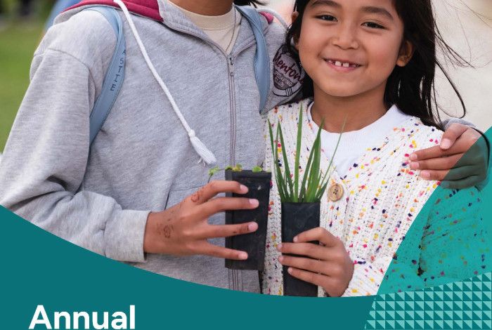 Two children holding small plants
