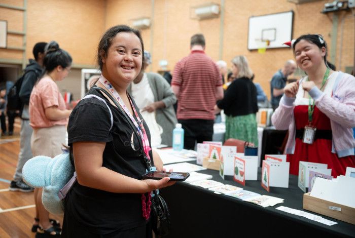 Disability pride stallholder and attendee.