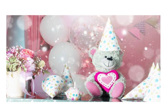 A teddy bear with party decorations