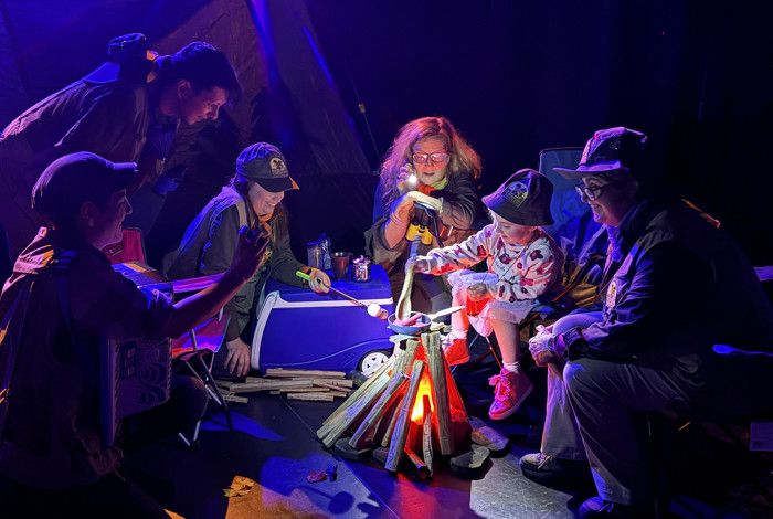 Camping tent and mock fire in a theatre