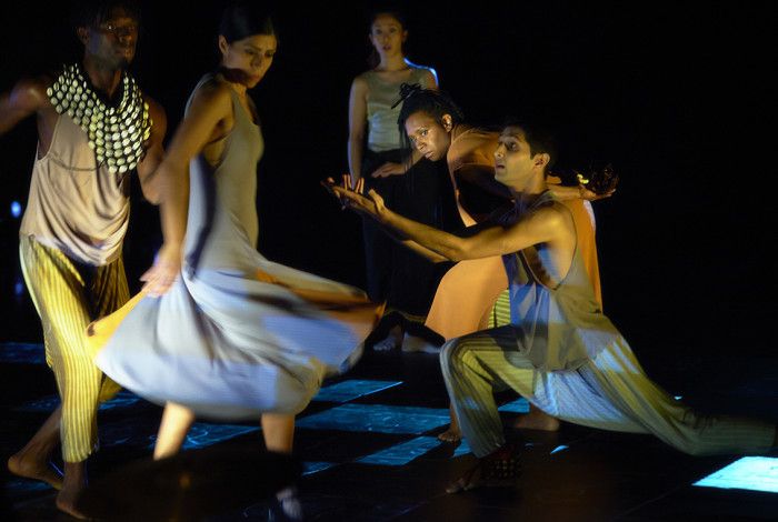 People performing moving and performing on stage