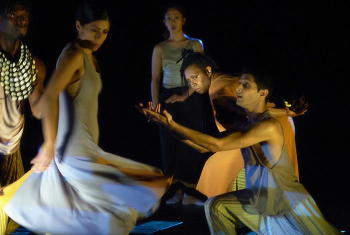 People moving and performing on stage