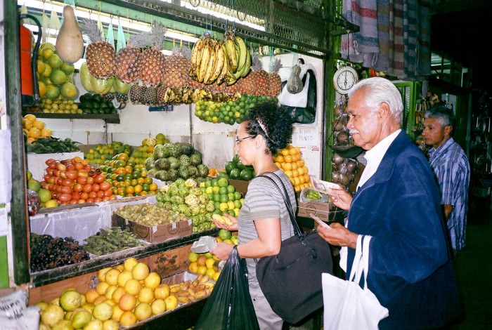 People buying fruit at a stall
