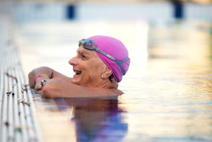 Older women leaning on edge of the pool in the water