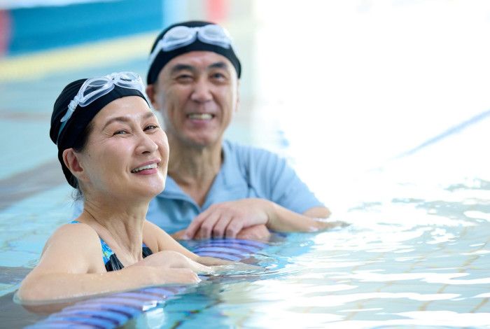 Two adults in the pool smiling