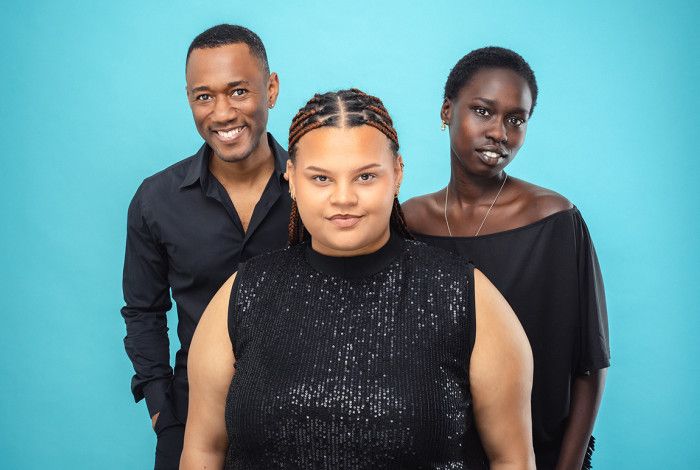 Three people smiling