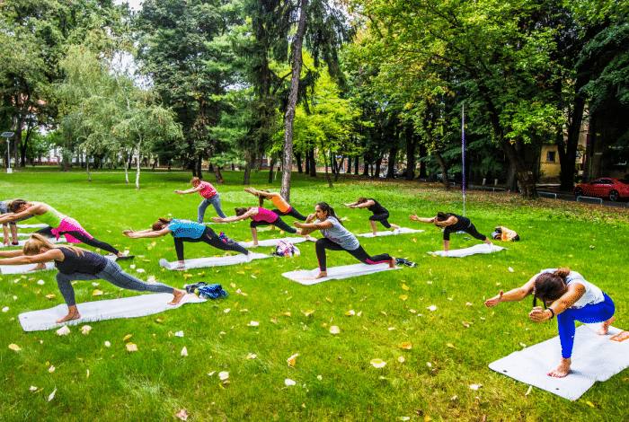 Group of women doing pilates in a park