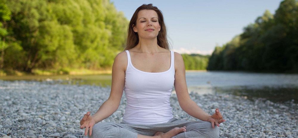 A person sitting doing Yoga